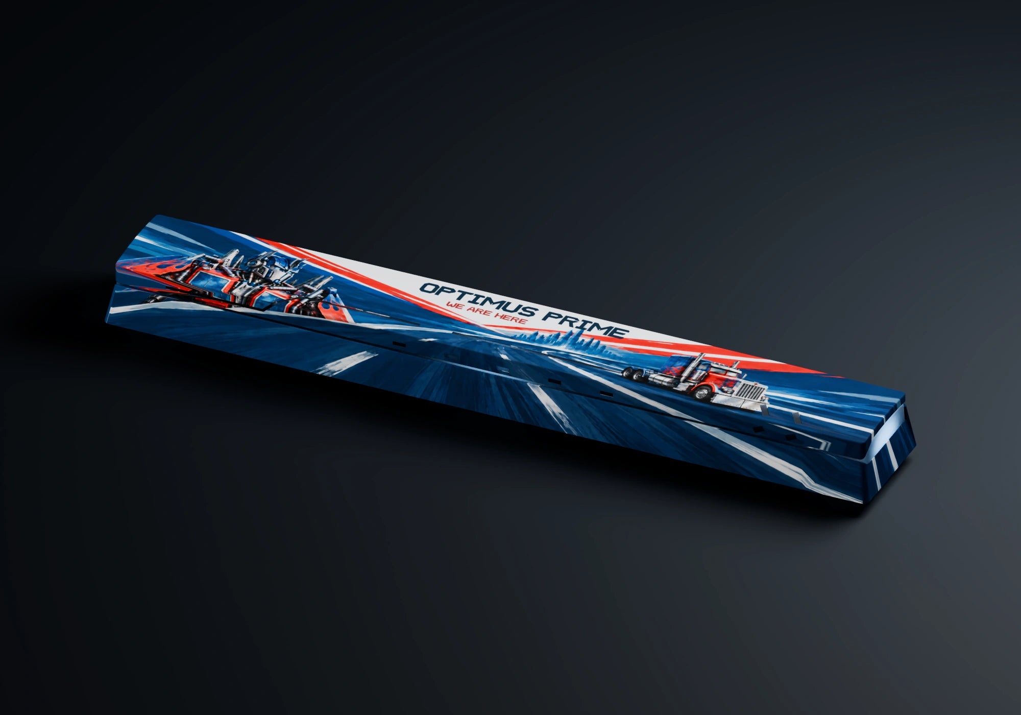 The complete sculpted spacebar with Optimus Prime and his truck printed across its surface
